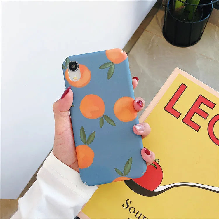 Plastic iPhone case with retro orange fruit and water design on blue background.