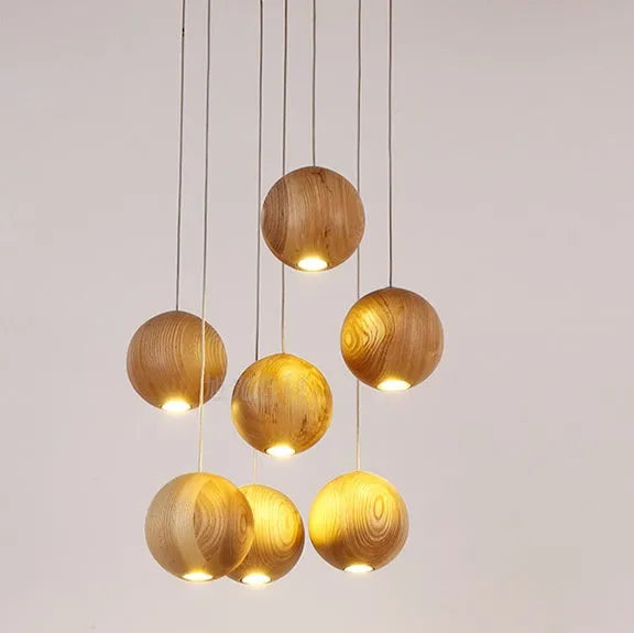 Nordic-style solid wood ball chandelier with adjustable cord and wood disc shade.