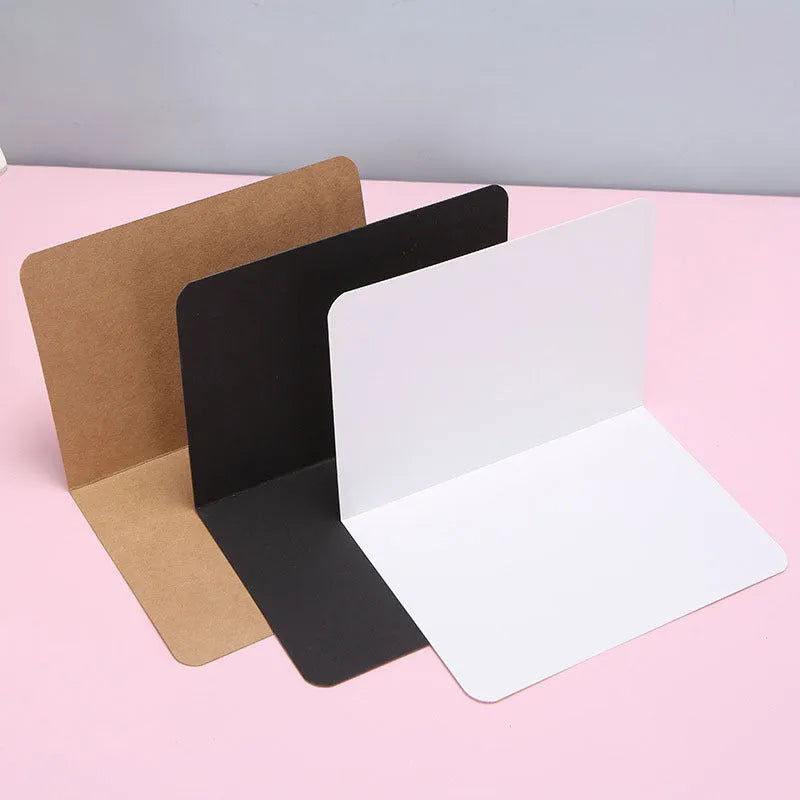 Folded kraft cards 10x15cm in black, cowhide, and white colours, 100 pack, blank surface for DIY invitations and crafts