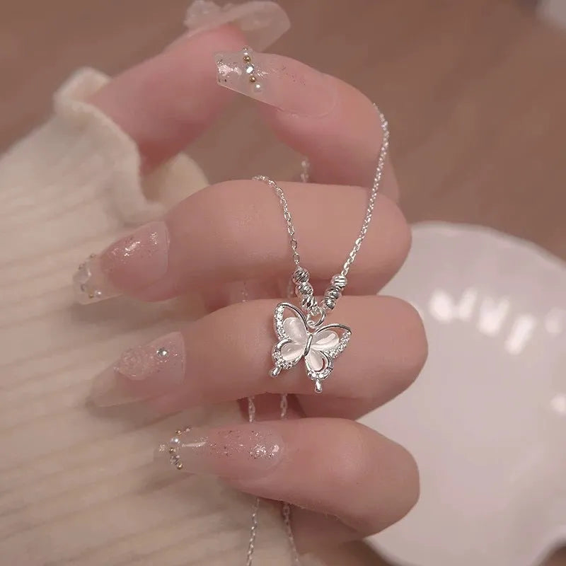 Silver women's butterfly necklace with square line opal pendant on an adjustable cross chain.
