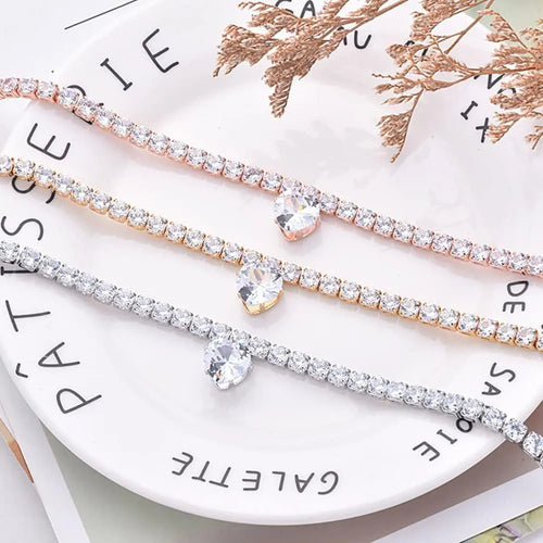 Gold rhinestone heart-shaped dog collar with bling design on a white background.