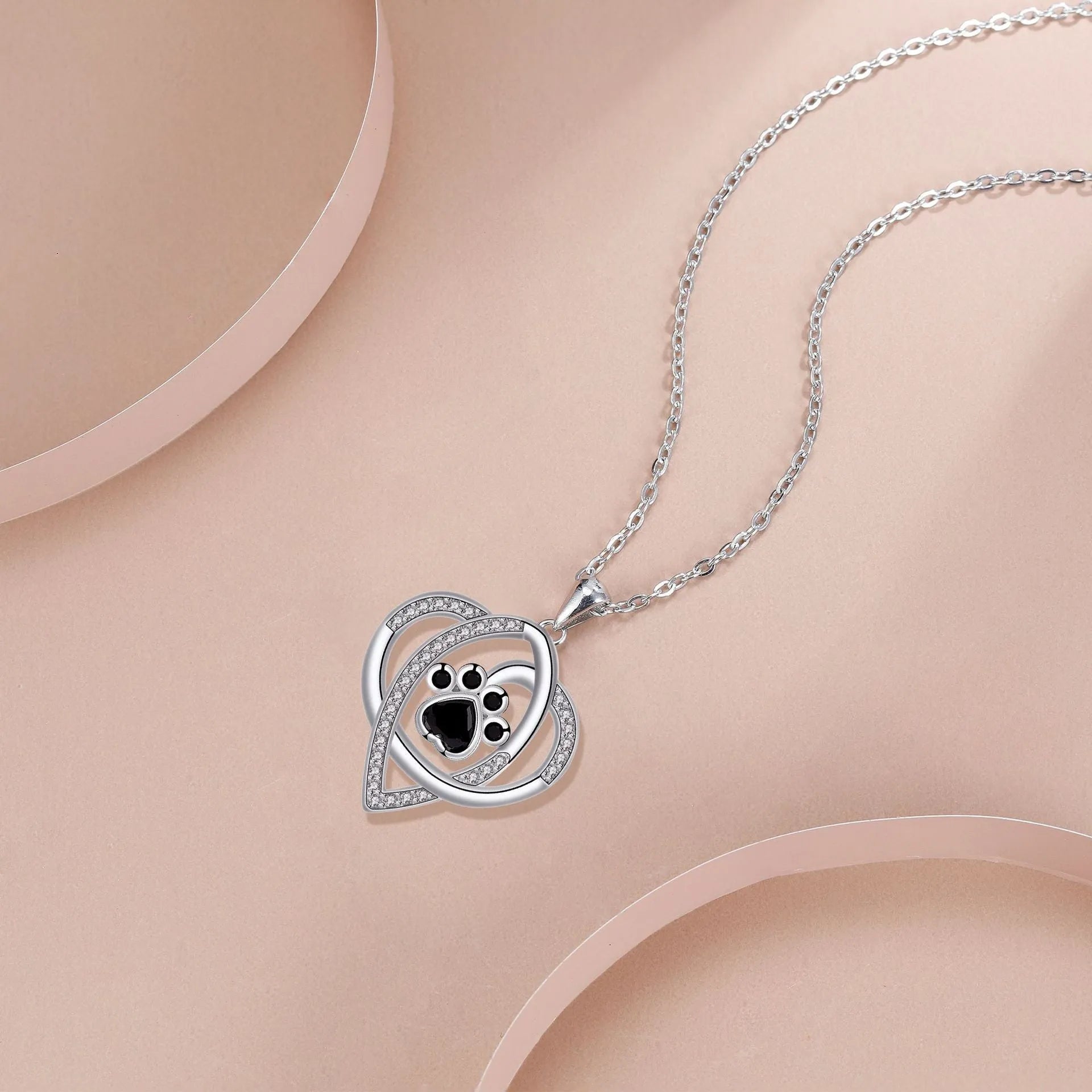 Gold necklace with cat and dog paw prints pendant on cross chain