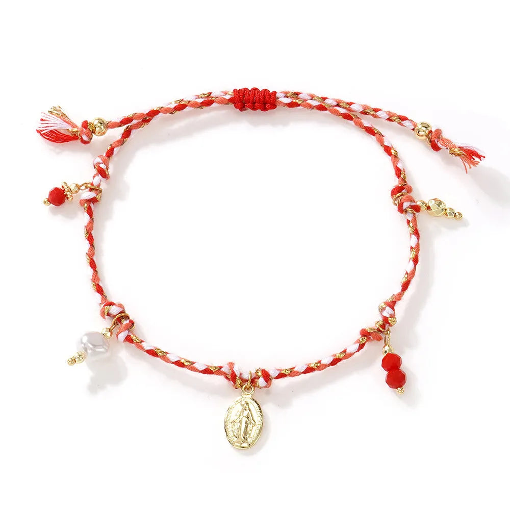 Close-up of a colourful hand-woven adjustable bracelet with an ethnic-style strap tag on a wrist.