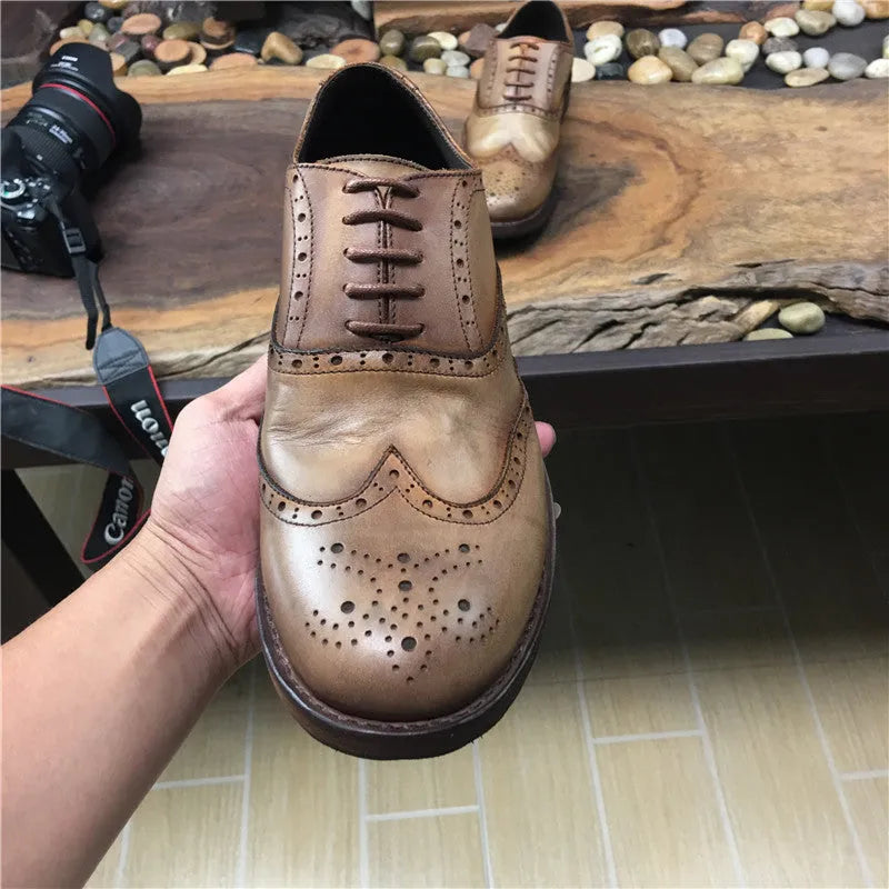 Men's light brown leather lace-up shoes with hand-distressed carving detail on the upper and a round toe.