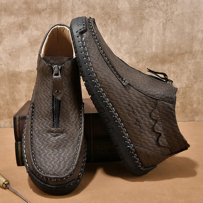 Men's black slip-on loafers with round toe and rubber sole on a white background.