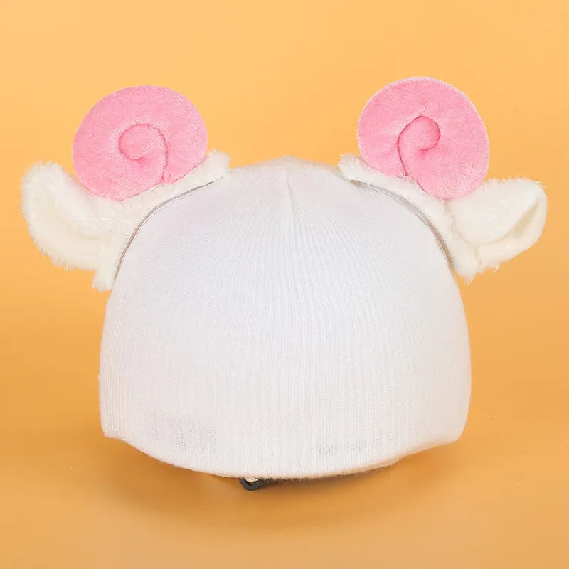 Colourful plush cartoon hat decoration sitting on top of a ski helmet