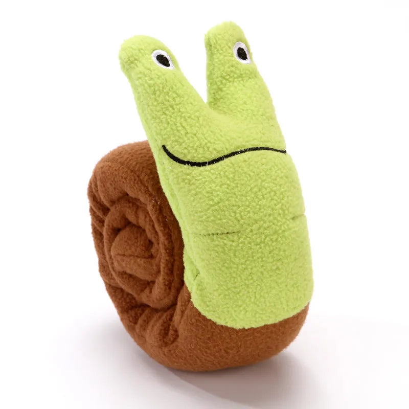 Green transformable plush dog toy shown in snail and stick shapes with squeakers and food holes.