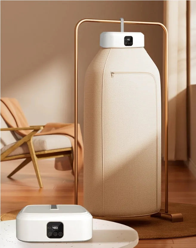 White cylindrical portable clothes dryer with remote control, folded for compact storage
