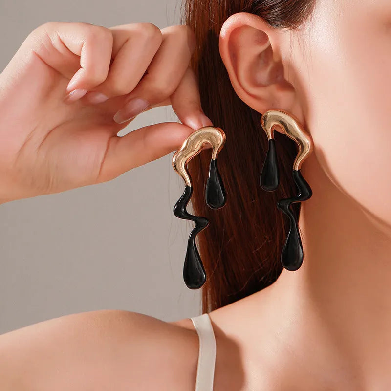 Liquid irregular geometric ear studs in gold, made from zinc alloy with electroplated finish, unique water drop design for women