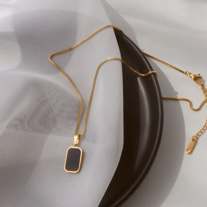 Rectangular pendant necklace in 18K gold plated titanium steel with box chain, black geometric design, 41-50cm.