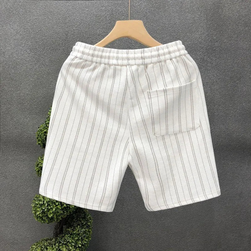 Men's black and white striped casual polyester shorts with an elastic waistband.