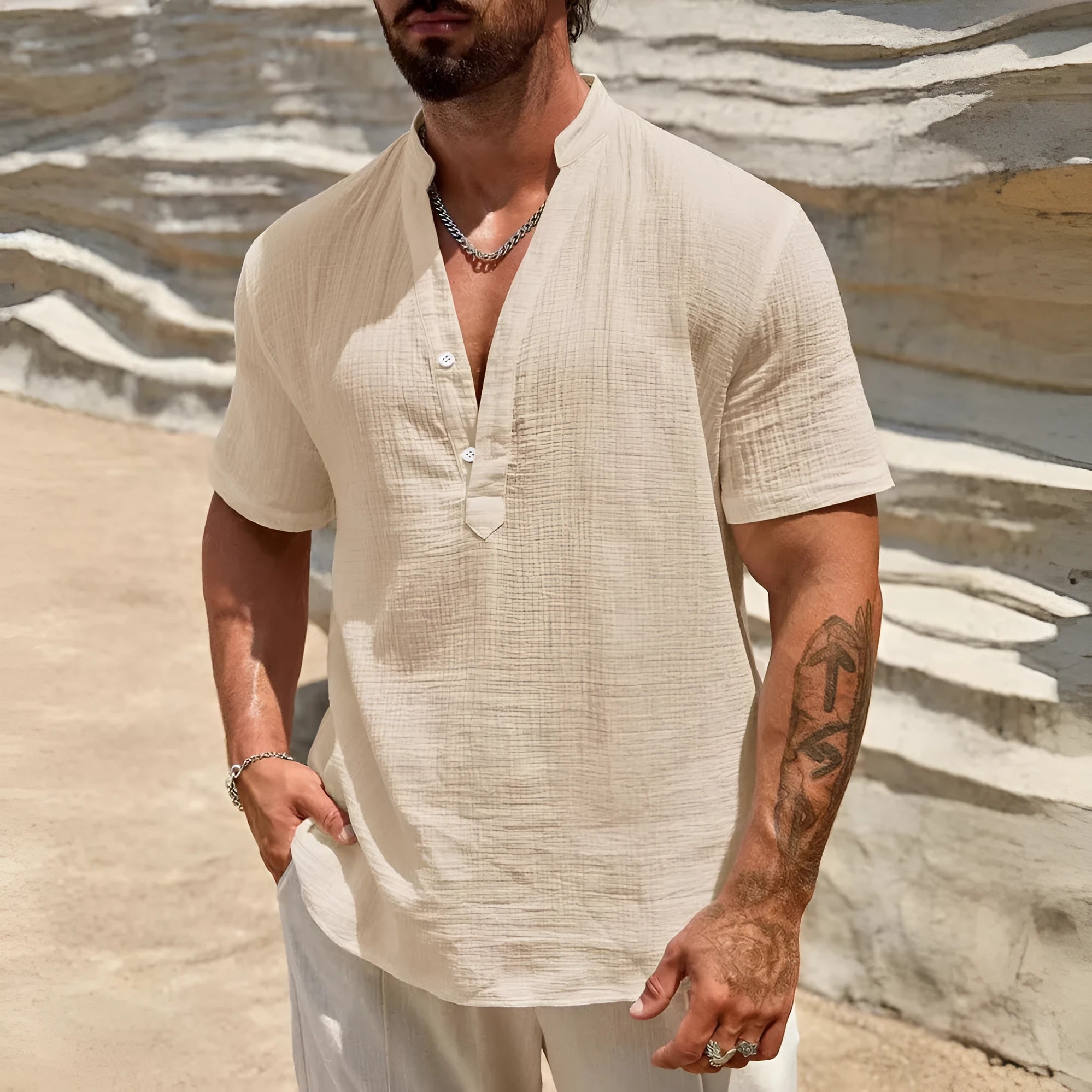 Man wearing a thin light blue stand collar short-sleeved casual shirt.