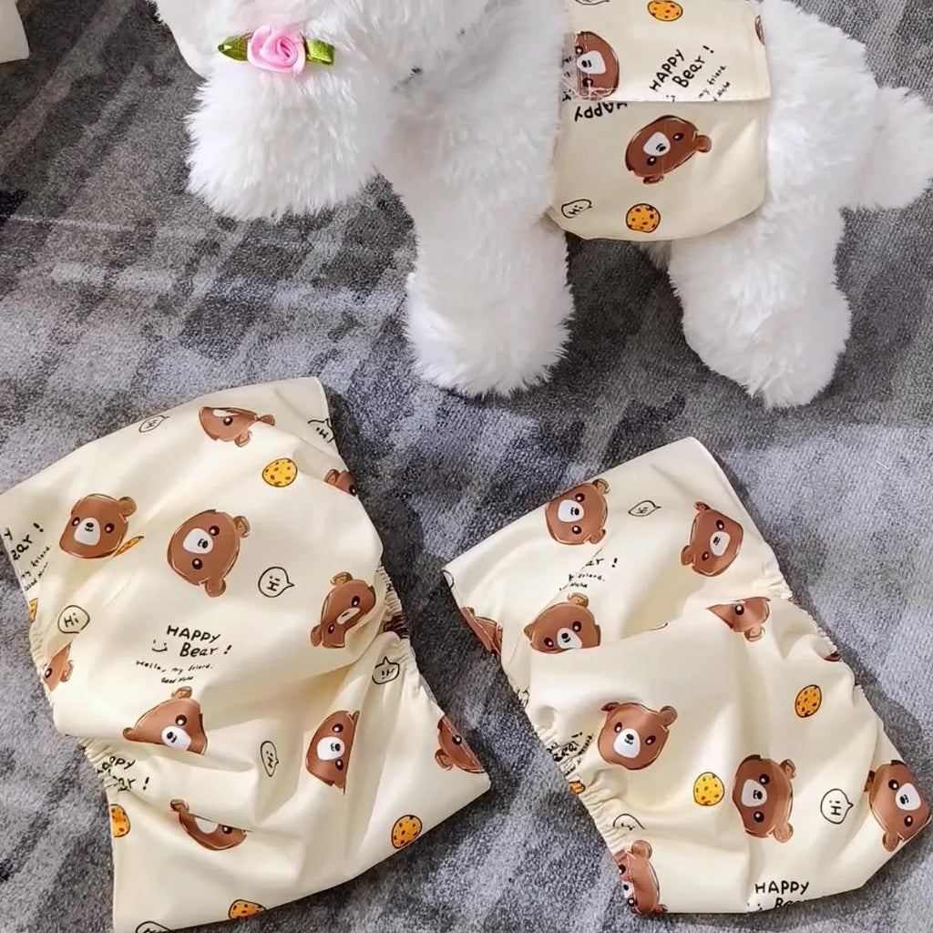 Reusable cartoon bone print dog diaper with fastener tape and elastic waistband, shown in blue bear pattern.