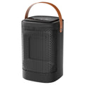 Silver touch screen electric radiator heater with remote control on a wooden desk.