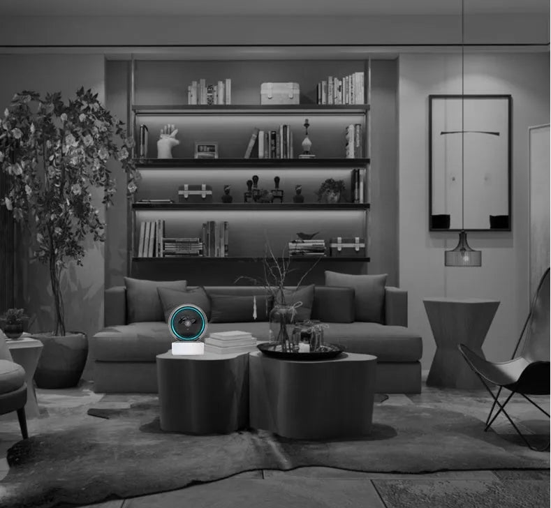 White indoor WiFi security camera with 360-degree rotation on a stand.