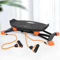 Black mini indoor fitness skiing machine with elastic hand straps on a home floor.