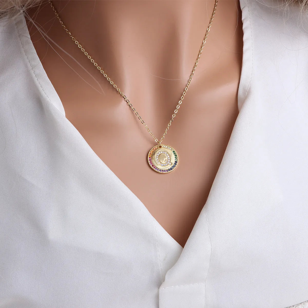 Gold English letter round pendant necklace with colourful crystals on clavicle length chain