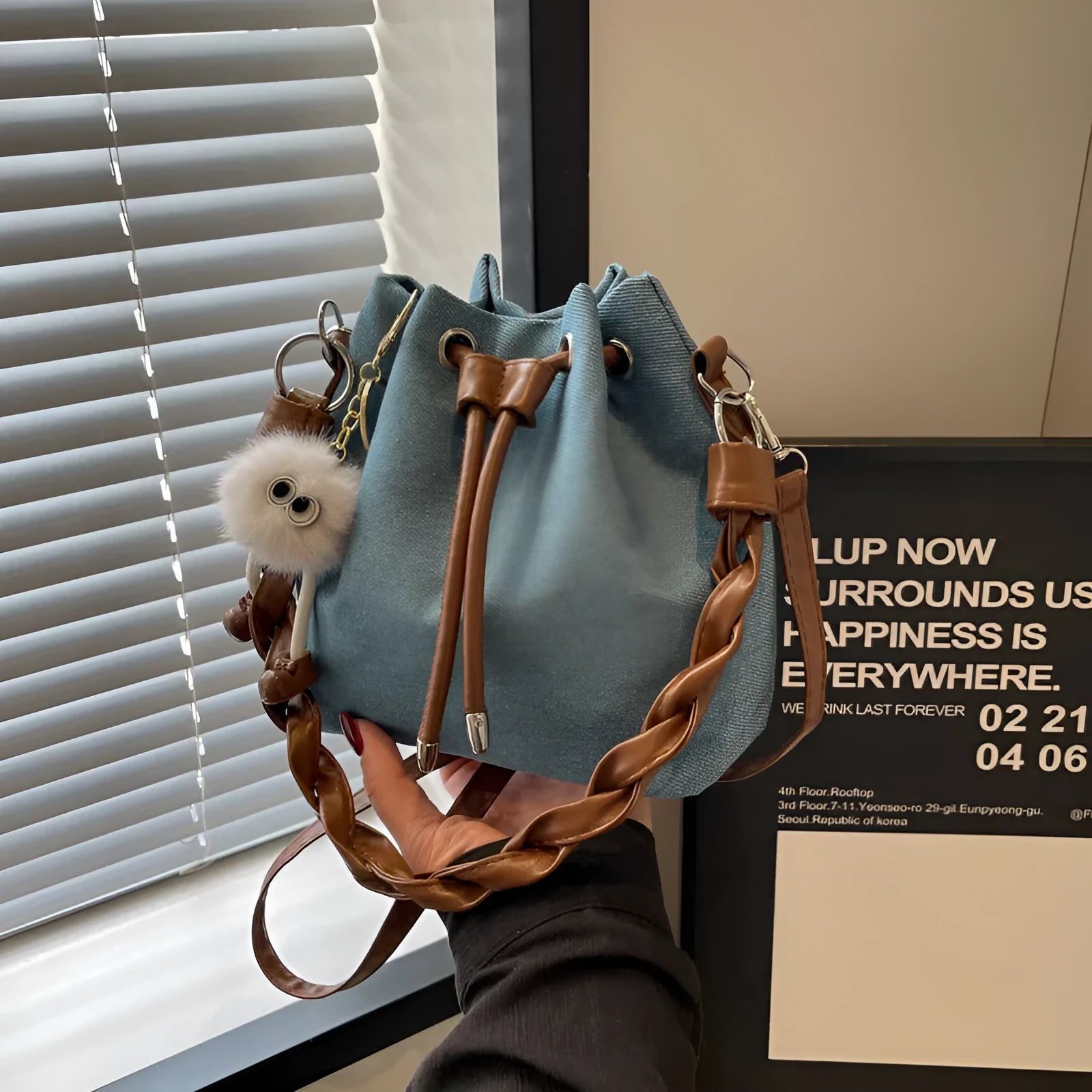 Blue synthetic leather cross body bucket bag with messenger design and shoulder strap