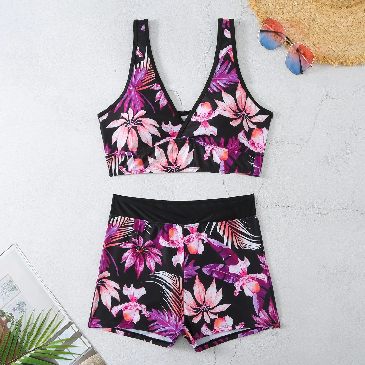 Women's two-piece swimsuit with sleeveless top and printed boxer brief bottoms in a multi-colour pattern.