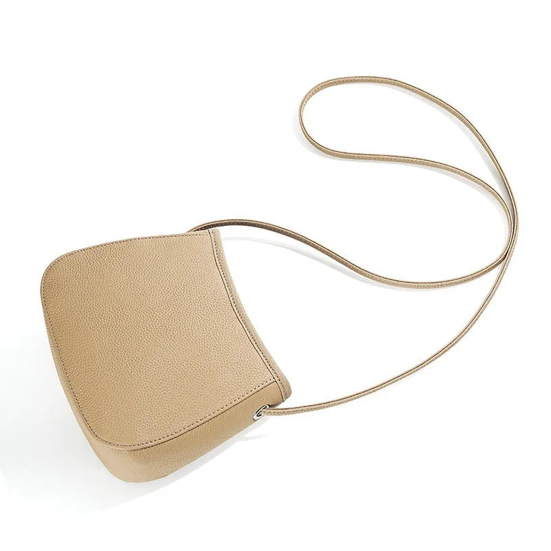Soft genuine cowhide women's messenger bag in a square vertical shape with a loading handle.