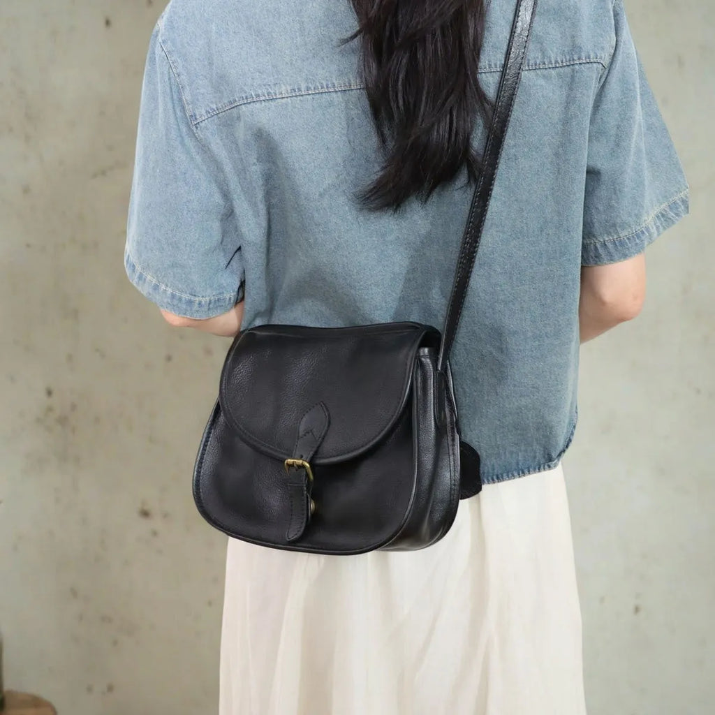 Brown genuine leather messenger bag with flap closure and crossbody strap showing internal organiser compartments