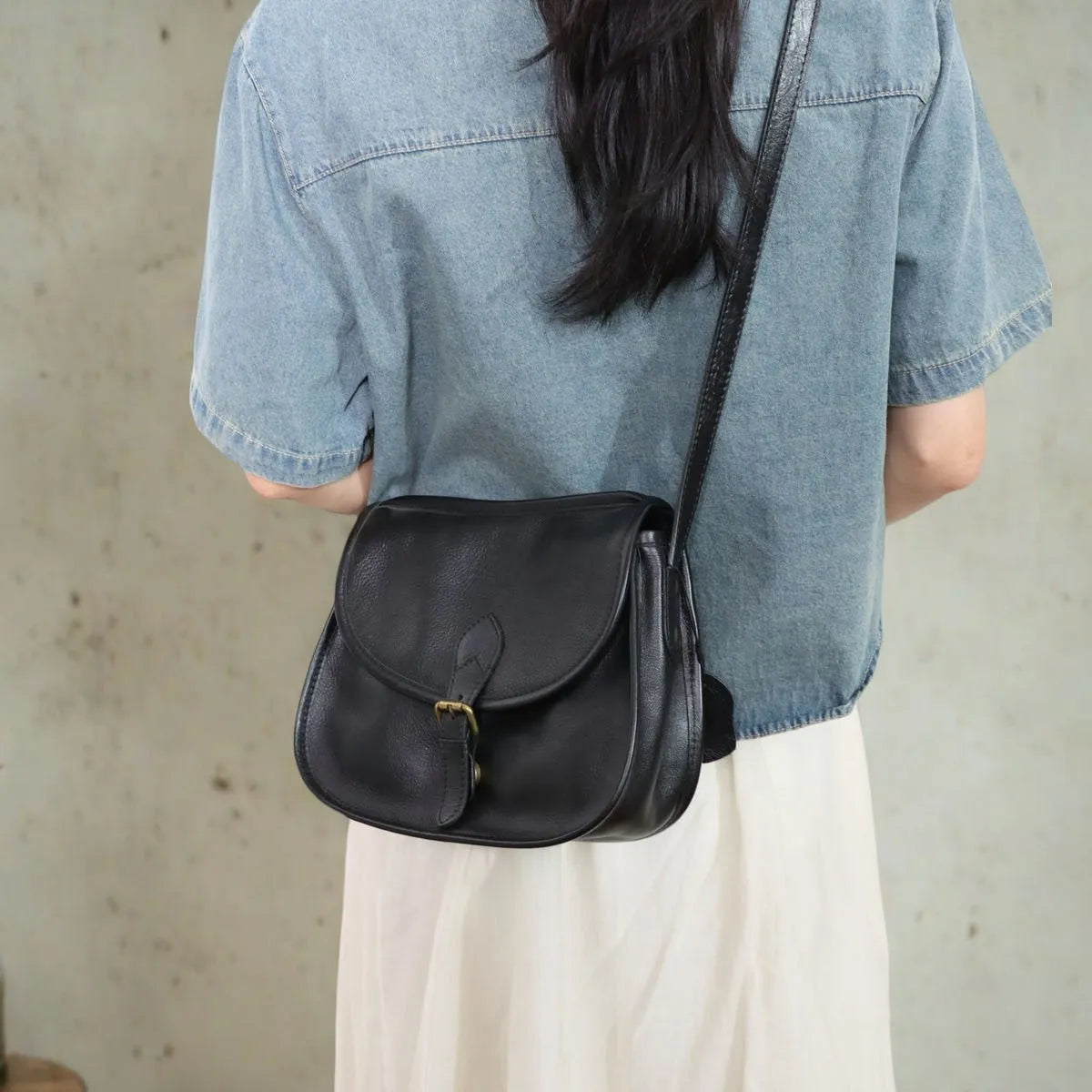Brown genuine leather messenger bag with flap closure and crossbody strap showing internal organiser compartments