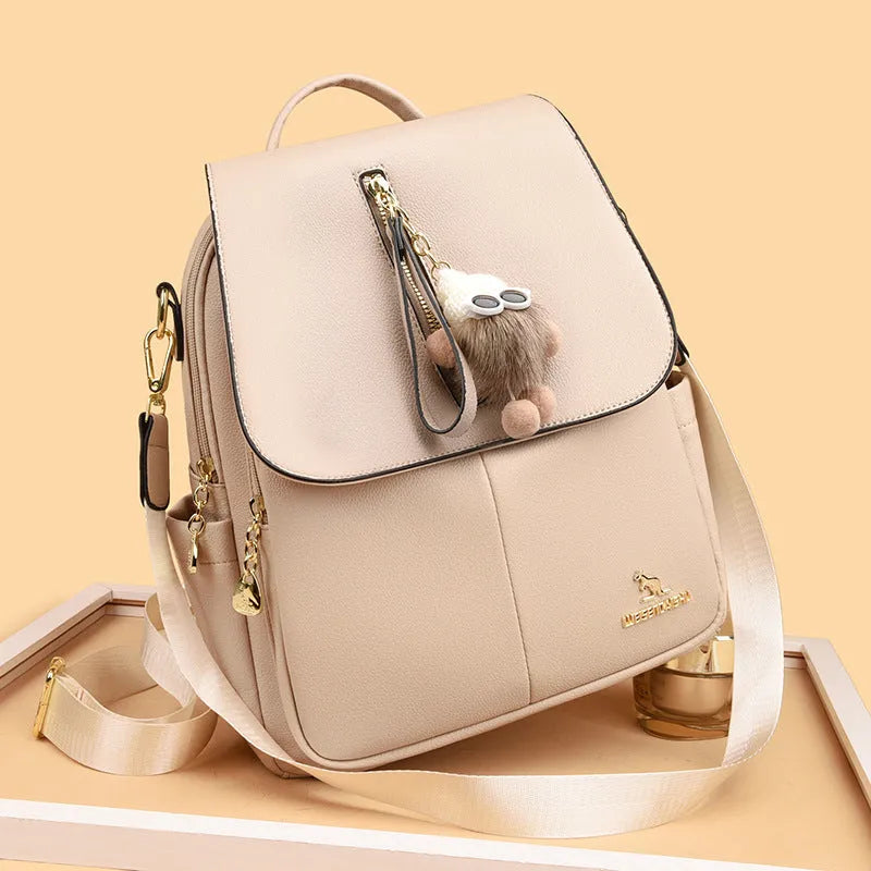 Genuine leather backpack with pendant and spliced belt detail for students and travellers, available in beige