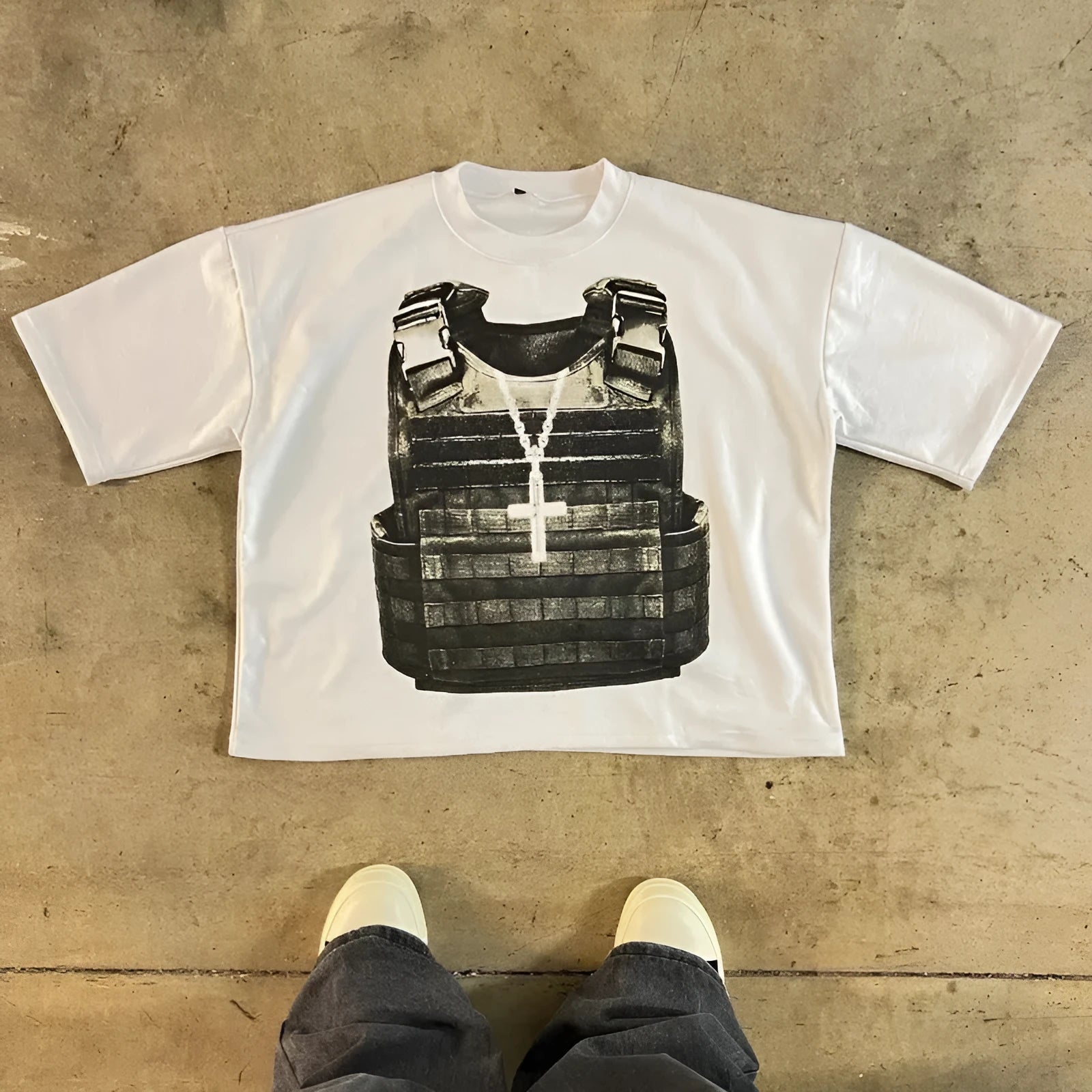 Person wearing a relaxed-fit grey cotton t-shirt with a retro-style graphic print and drop-shoulder sleeves.