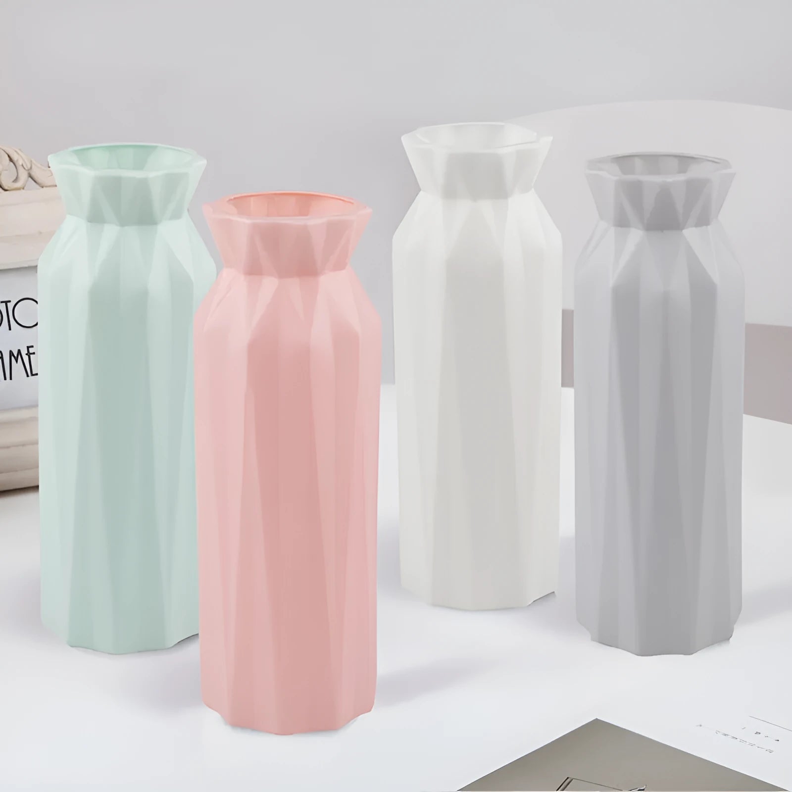 Green plastic melamine vase with a wide, stable base on a wooden surface.