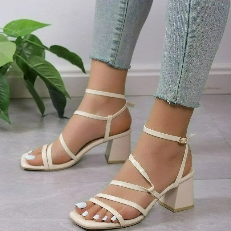 Beige women's open toe slippers with an adjustable ankle buckle, showing the square toe shape and rubber sole.