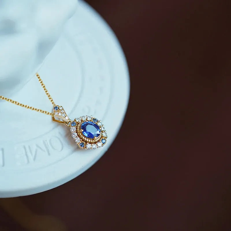 Huitan yellow gold necklace with adjustable chain and sparkling inlaid zircon gem pendant on a model.