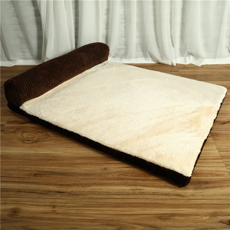Grey corduroy dog sofa bed with raised sides and a non-slip base on a wooden floor.
