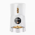 Black automatic pet feeder with digital timer display and food hopper.