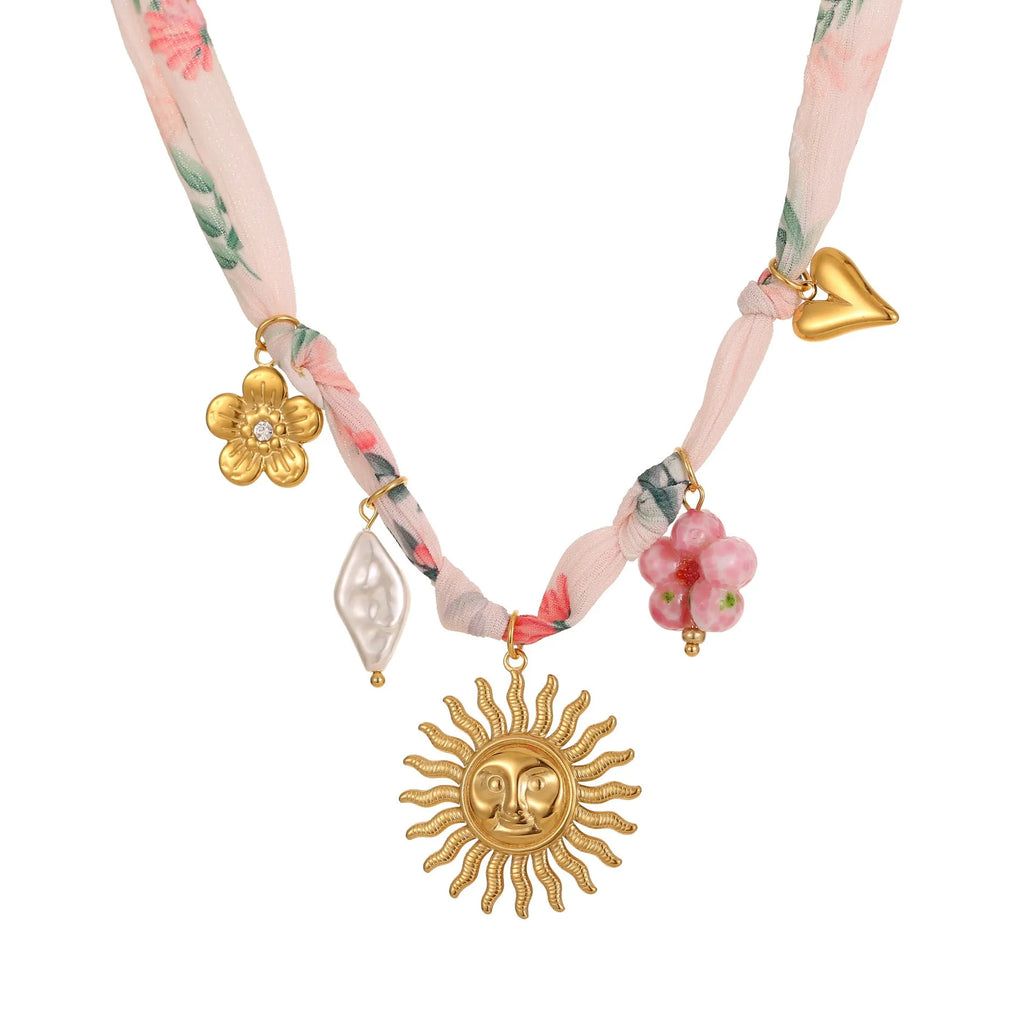 Stainless steel geometric sun pendant necklace with adjustable chain on dark background
