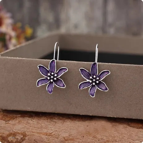 Close-up of a pair of purple alloy flower-shaped earrings with a retro elegant style.