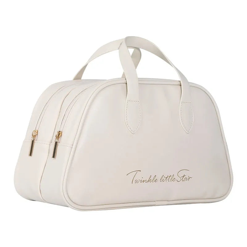 Leather travel toiletry bag open showing dry-wet separation compartments in caramel mocha colour