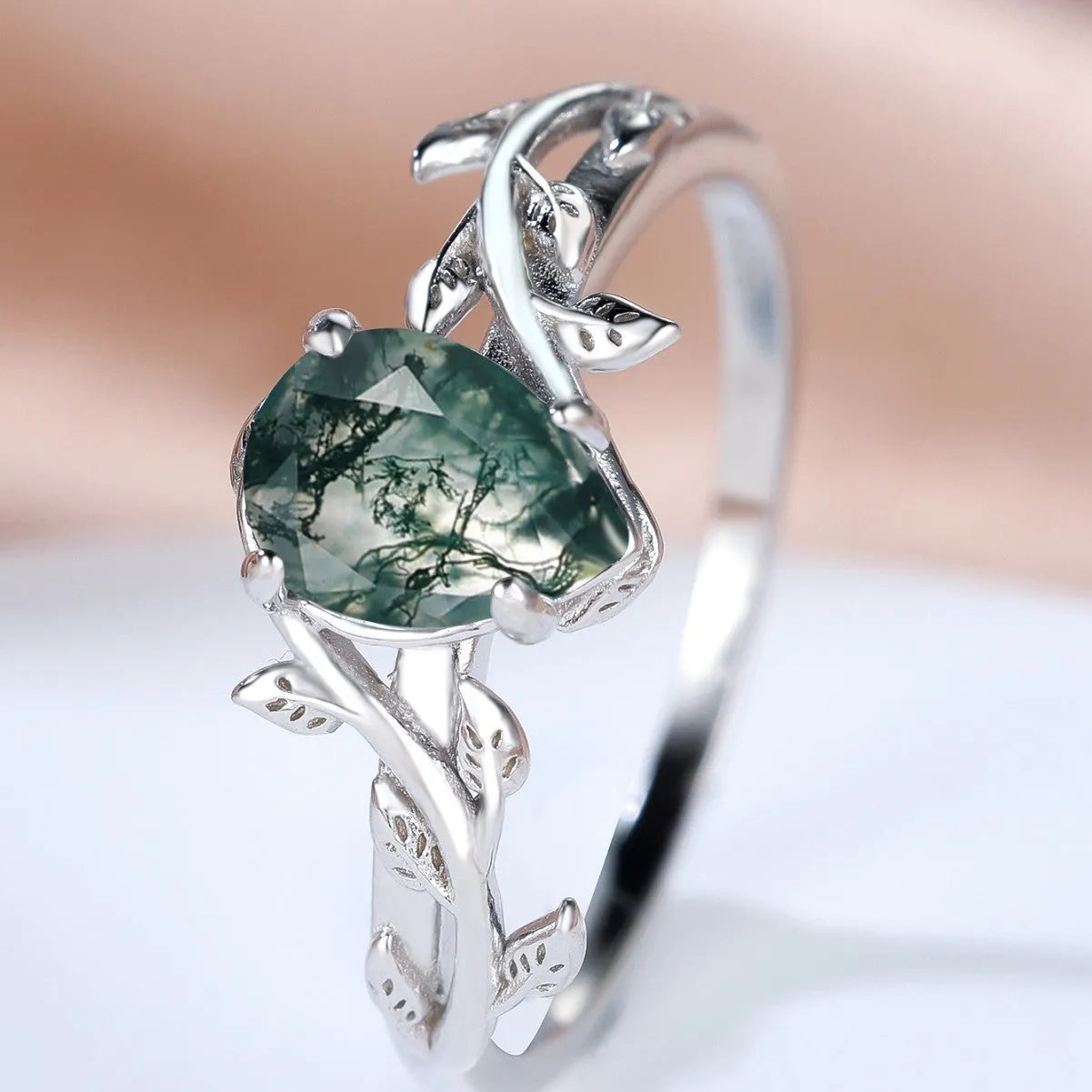 S925 silver ring with drop-shaped natural agate stone and branch leaf edge design on white background