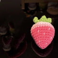 Soft plush strawberry-shaped pendant keychain in pink or red colour.