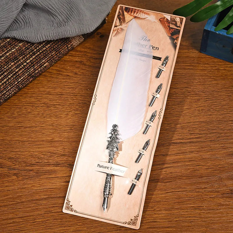 Vintage feather dip pen with zinc alloy holder in assorted colours on a wooden desk