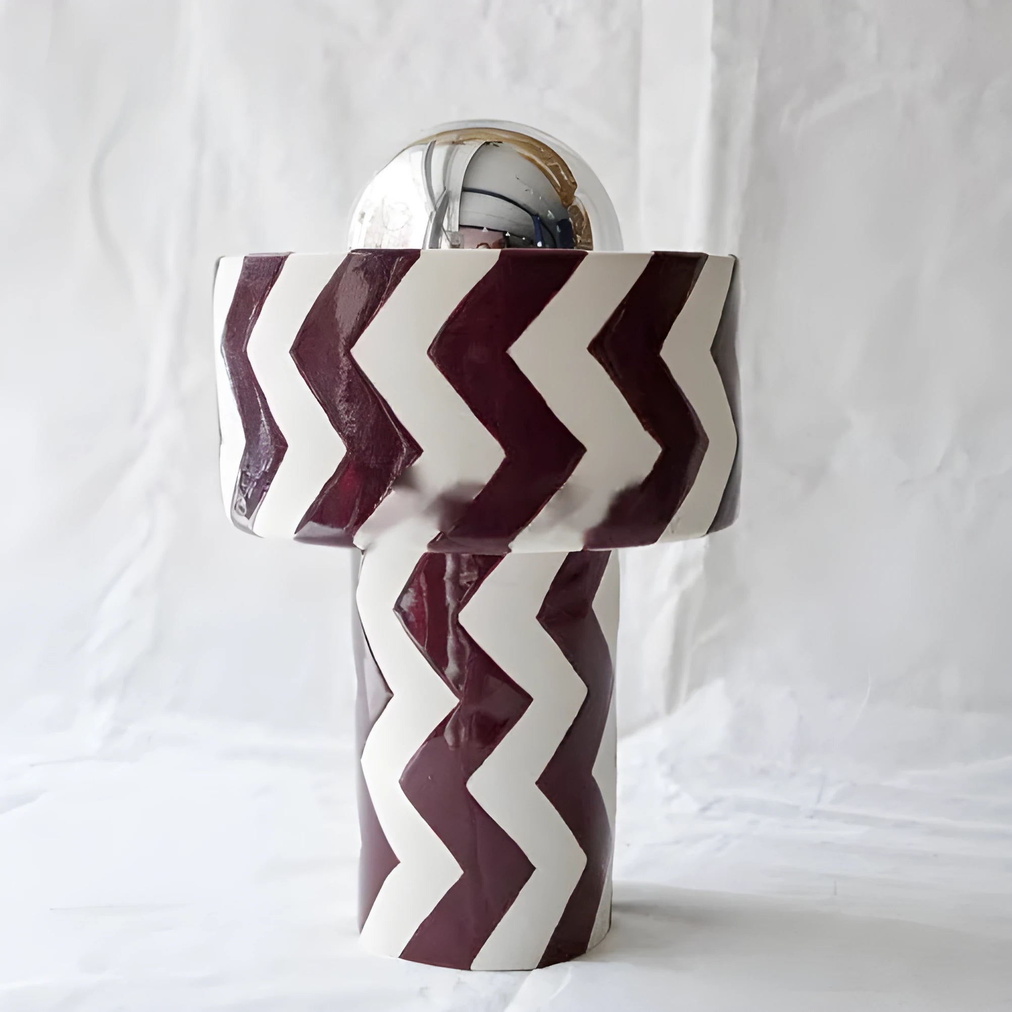 Striped table lamp with matte finish, pushbutton switch, and UK plug on a desk