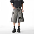 Grey water washed denim shorts with hole detailing and loose retro fit