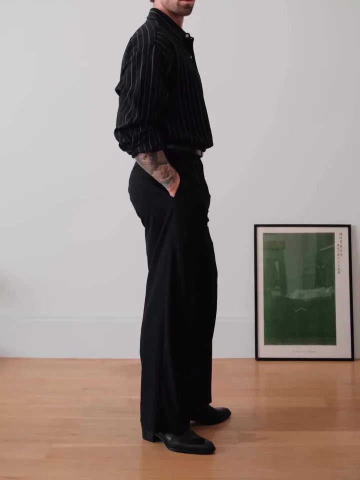 Men's black pinstriped polyester button-down shirt laid flat, showing regular fit and striped pattern.