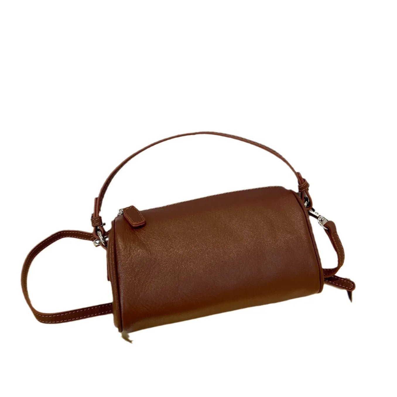 Genuine leather cylindrical crossbody phone bag in black, shown with single shoulder strap and visible sewing thread detail.