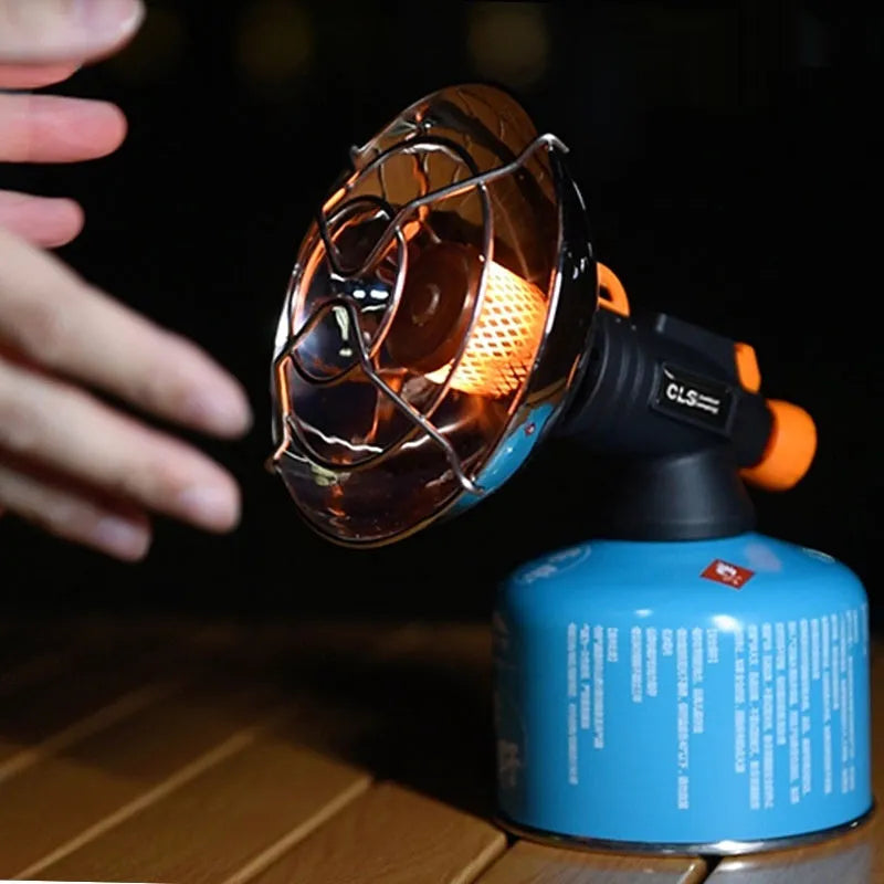 Black and orange portable outdoor heating stove with automatic ignition for camping.