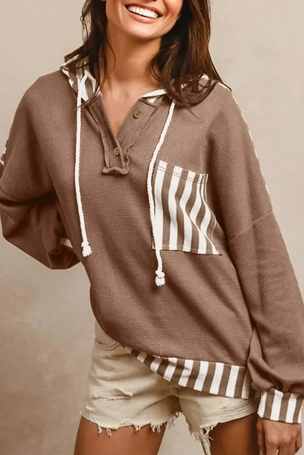 Straw yellow women's hoodie with waffle texture, patchwork stripes, button neck, and drawstring hood.