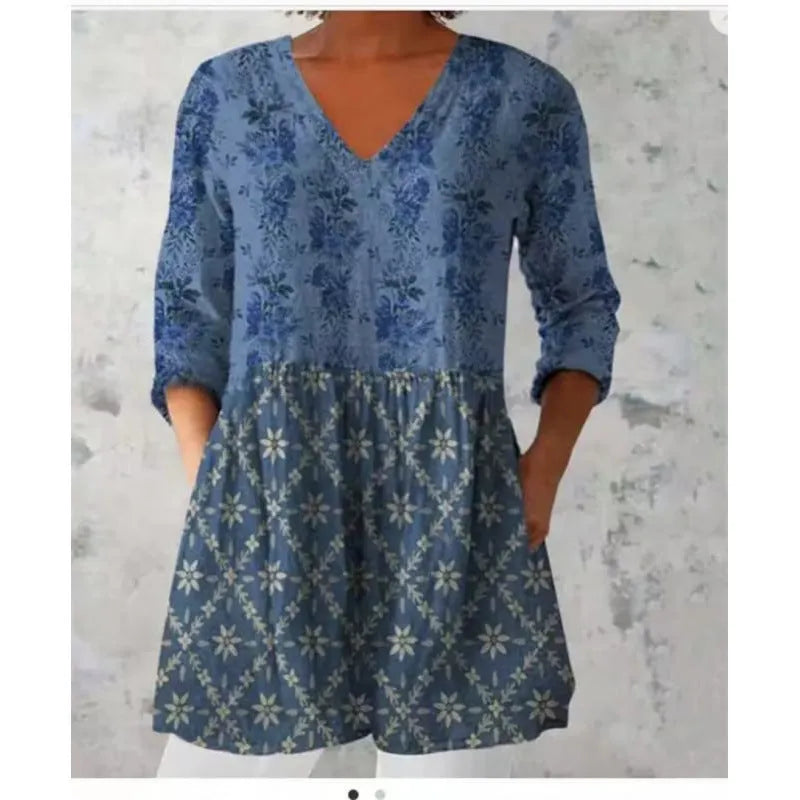 Women's loose-fit printed dress with wide waist and three-quarter length sleeves.