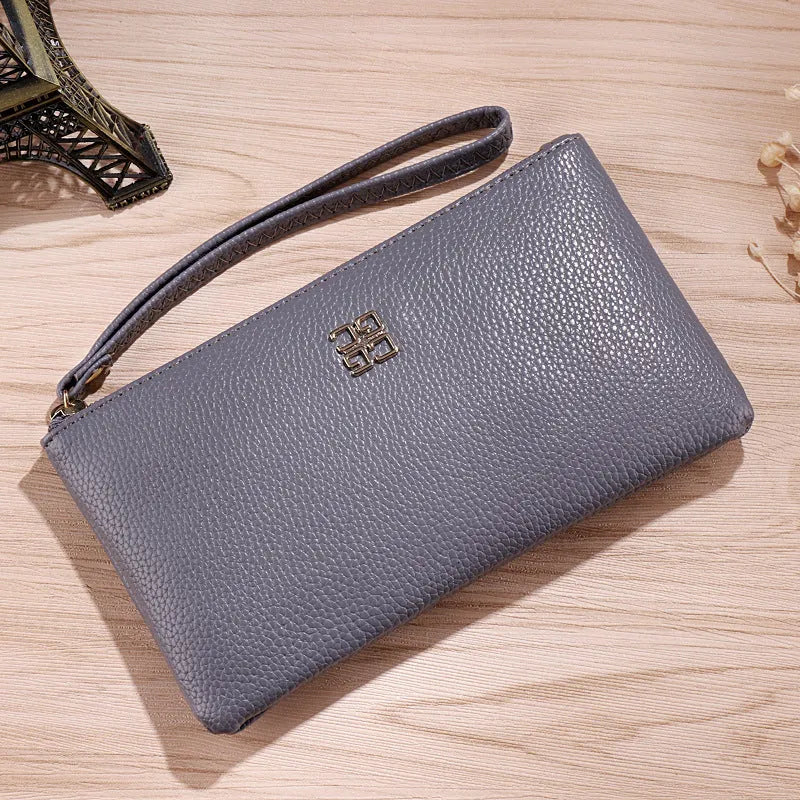 Long wine red PU leather phone wallet handbag with zip open showing card slots and phone compartment.