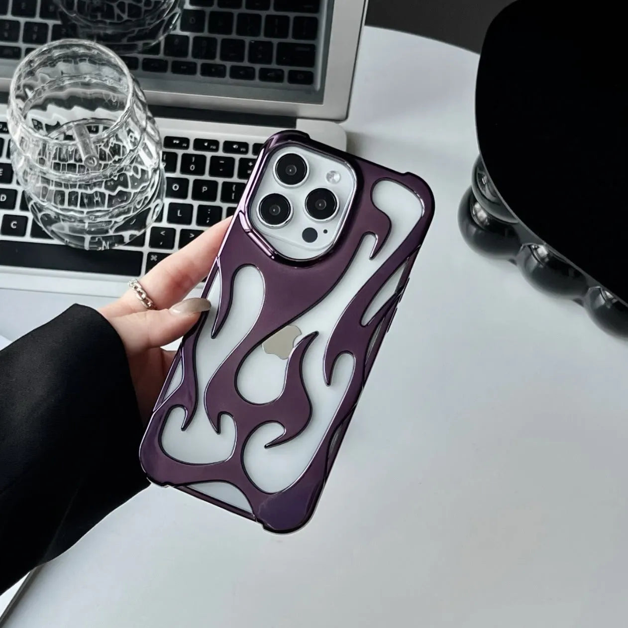 Electroplated hollow flame pattern phone case for iPhone, showing silver finish and perforated design for heat dissipation.