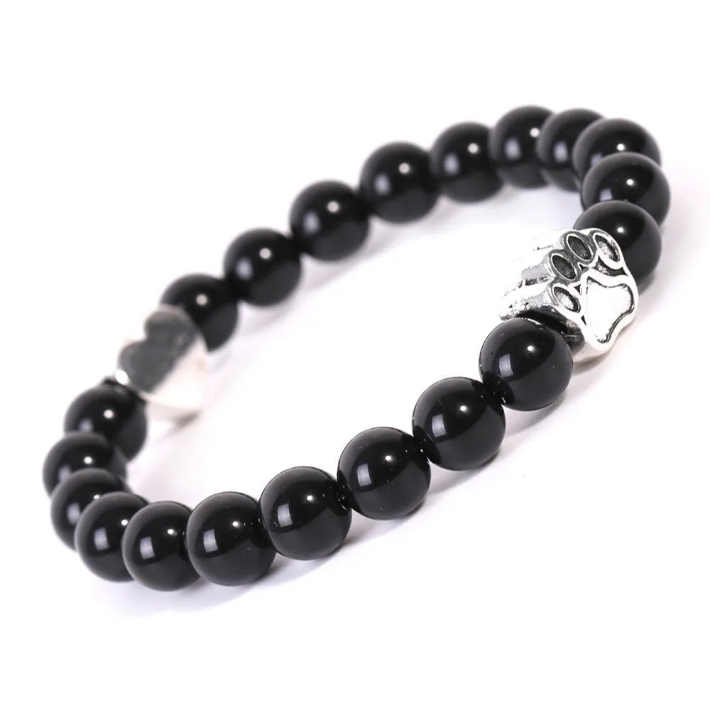 Tiger's Eye stone beaded bracelet with a geometric dog's paw design on a wrist.