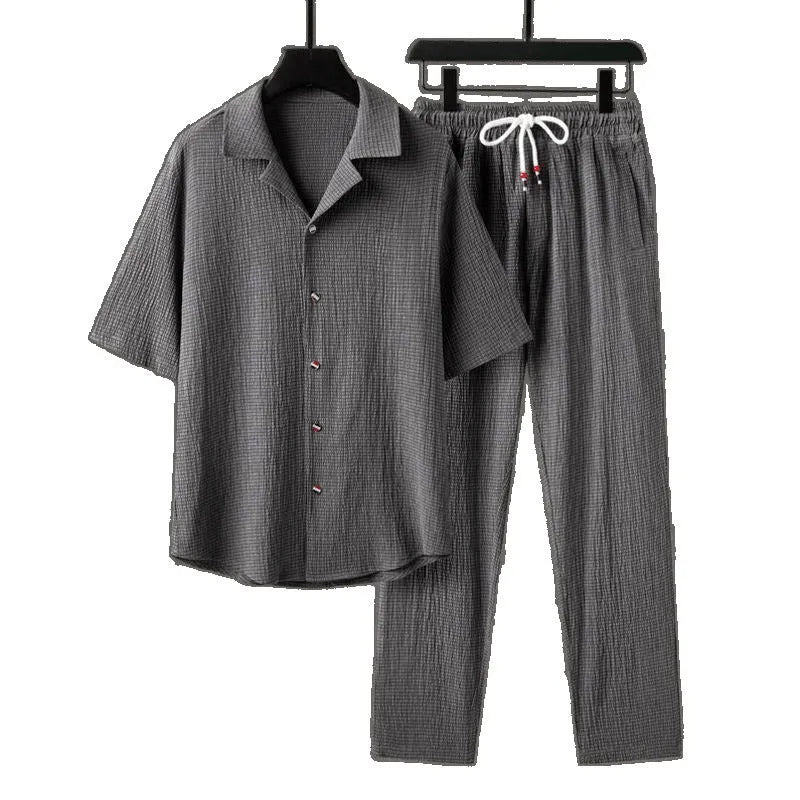 Men's grey Chinese-style casual two-piece sportswear set with short sleeve top and trousers on a hanger.